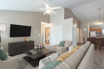 Webster apartment for rent - A living room with a white couch and a black TV on the wall.
