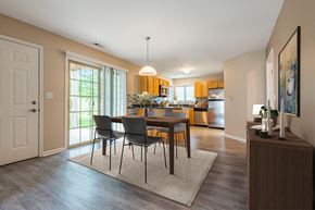 Webster apartment for rent - A dining room with a table and chairs is shown.