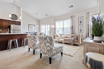 North Chili apartment for rent - a living room and kitchen with a couch and chairs