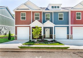 Spartanburg apartment for rent - a house with two garage doors and a lawn in front of it