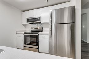 Grand Rapids apartment for rent - a kitchen with stainless steel appliances and white cabinets
