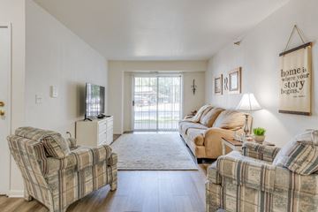 Grand Rapids apartment for rent - a living room with couches and chairs and a sliding glass door