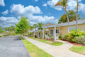 Jensen Beach apartment for rent - trim landscaping, neat sidewalks, and mature landscaping in front of villas