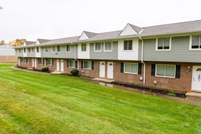 Medina townhouse for rent - a row of houses with a yard in front of them