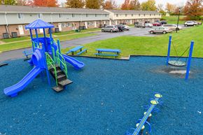Medina townhouse for rent - a playground with a swing set and slides in a park