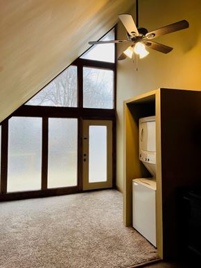 Jonesboro apartment for rent - A room with a ceiling fan and a window with a view of trees.