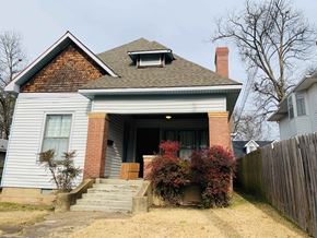 Jonesboro apartment for rent - A house with a brick chimney and a grey roof.