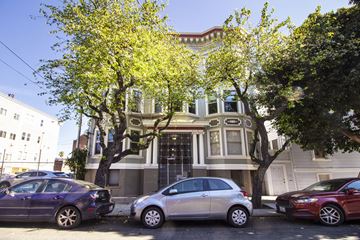 San Francisco apartment for rent - Three cars parked in front of a two-story building.
