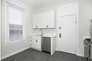 San Francisco apartment for rent - A kitchen with white cabinets and a stainless steel dishwasher.