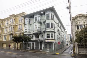 San Francisco apartment for rent - A street view of a row of Victorian style houses with a "No Stopping" sign on the sidewalk.