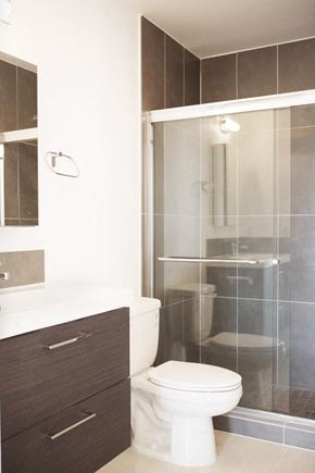 Los Angeles apartment for rent - A white toilet sits next to a walk-in shower.
