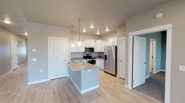 Fargo townhouse for rent - A kitchen with a refrigerator, sink, and cabinets is shown.