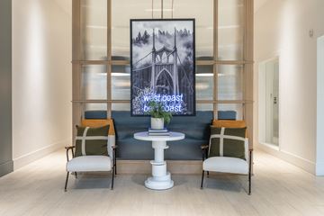 Portland apartment for rent - a living room with a white table and chairs and a poster on the wall