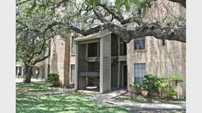 San Antonio apartment for rent - a brick apartment building with a tree in the yard