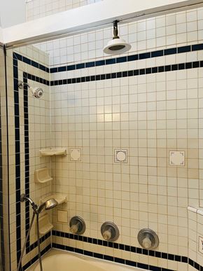 Jonesboro house for rent - a white tiled bathroom with a shower and a sink