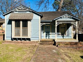 Jonesboro house for rent - a blue house with a porch and a sidewalk in front of it