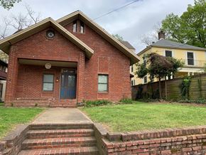 Jonesboro apartment for rent - A red brick house with a blue door and a small porch.