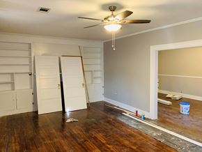 Jonesboro house for rent - a living room with a hard wood floor and a ceiling fan