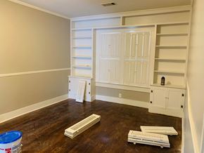 Jonesboro house for rent - a room with white shelves and a hard wood floor