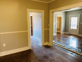 Jonesboro house for rent - an empty living room with the doorways open to the dining room and the kitchen