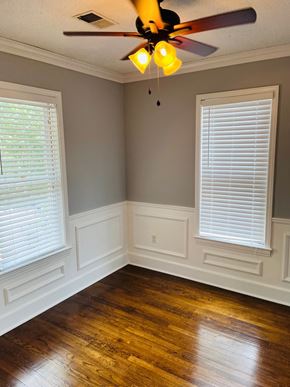 Jonesboro apartment for rent - an empty room with a ceiling fan and two windows