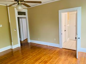 Jonesboro apartment for rent - an empty living room with wooden floors and a ceiling fan