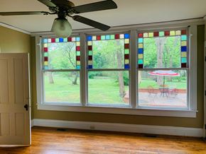 Jonesboro apartment for rent - a living room with a large window and a ceiling fan