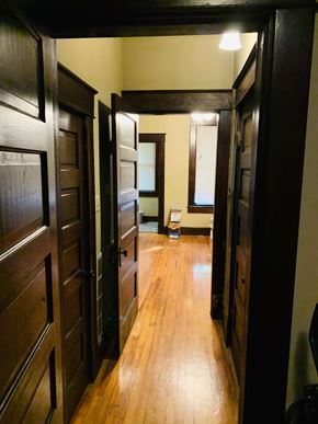 Jonesboro house for rent - a hallway with wooden floors and wooden doors