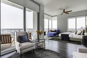 Atlanta apartment for rent - a bedroom with a bed and a living room with large windows