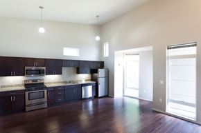 Cleveland apartment for rent - an empty kitchen with dark wood cabinets and stainless steel appliances