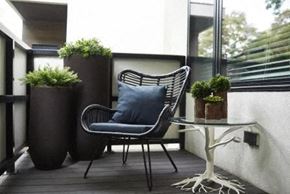 Cleveland apartment for rent - a chair and a table on a balcony with potted plants