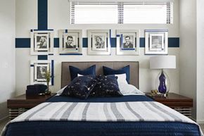 Cleveland apartment for rent - a blue and white bedroom with a bed and pictures on the wall