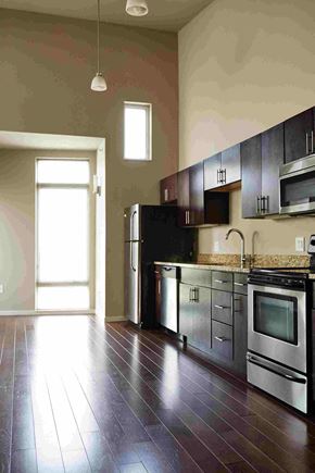 Cleveland apartment for rent - an empty kitchen with stainless steel appliances and wooden floors