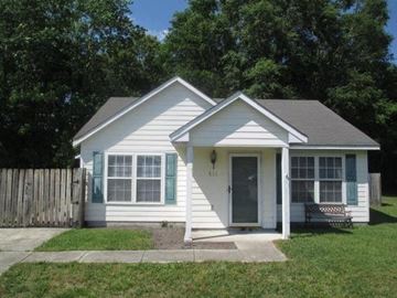 Jacksonville house for rent - A small white house with a grey roof and a grey door.