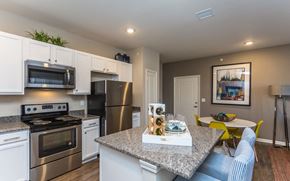 Brighton apartment for rent - a kitchen with stainless steel appliances and a granite counter top