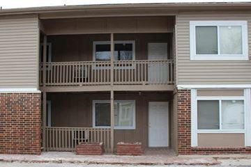 Olathe apartment for rent - A two-story apartment building with a balcony on the second floor.