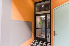 San Francisco apartment for rent - A door with a green sign on it is open.
