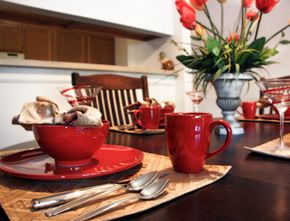 New Britain apartment for rent - a kitchen table with a cup of tea and a bowl of cookies