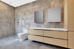 Ny apartment for rent - A modern bathroom with a walk-in shower and a white toilet.