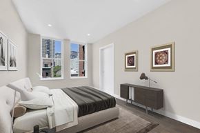 Ny apartment for rent - A bedroom with a large bed and a brown rug.