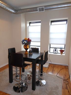 Chicago apartment for rent - a dining room with a table and chairs and two windows