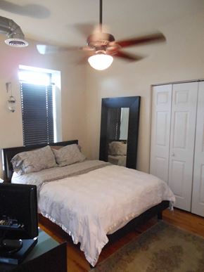 Chicago apartment for rent - a bedroom with a bed and a ceiling fan