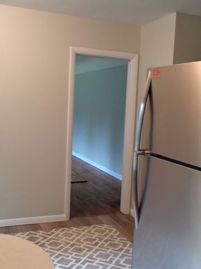 Kalamazoo house for rent - a kitchen with a refrigerator and an open door