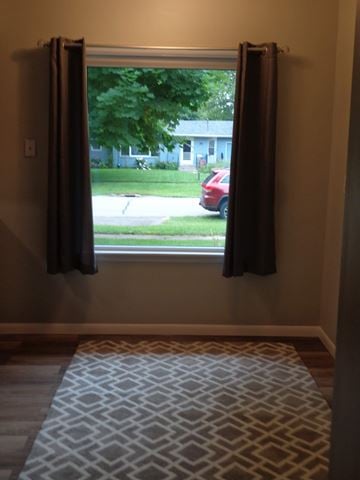 Kalamazoo house for rent - a living room with a window and a rug