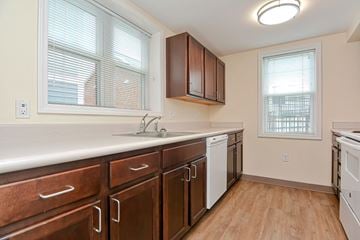 Holyoke apartment for rent - a kitchen with wooden cabinets and a sink and a window