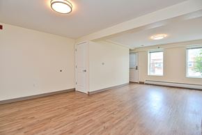 Holyoke apartment for rent - an empty living room with wood floors and white walls