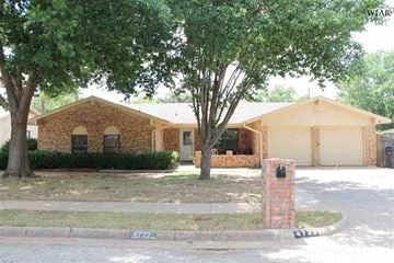 Wichita Falls house for rent - A brick house with a tree in front of it.