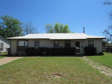 Wichita Falls house for rent - a white house with a metal roof on a lawn