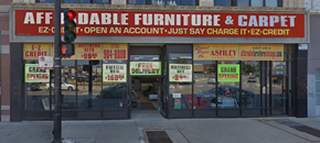Chicago apartment for rent - the front of a furniture and carpet store on a city street
