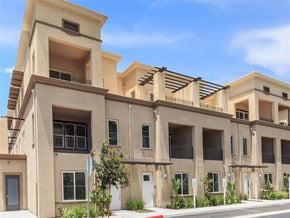 Oxnard townhouse for rent - a row of apartments with balconies and a street